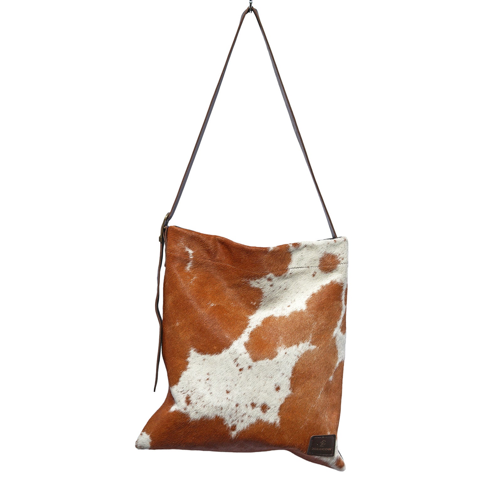 Brown Cowhide Messenger Bag, in a chestnut cow print, with a crossbody strap and yellow velvet lining.
