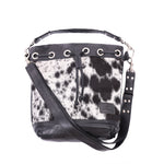 Ethically-made, cow print, leather bucket bag featuring distinctive cowhide front and leather back