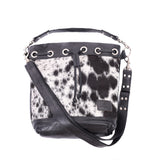 Ethically-made, cow print, leather bucket bag featuring distinctive cowhide front and leather back