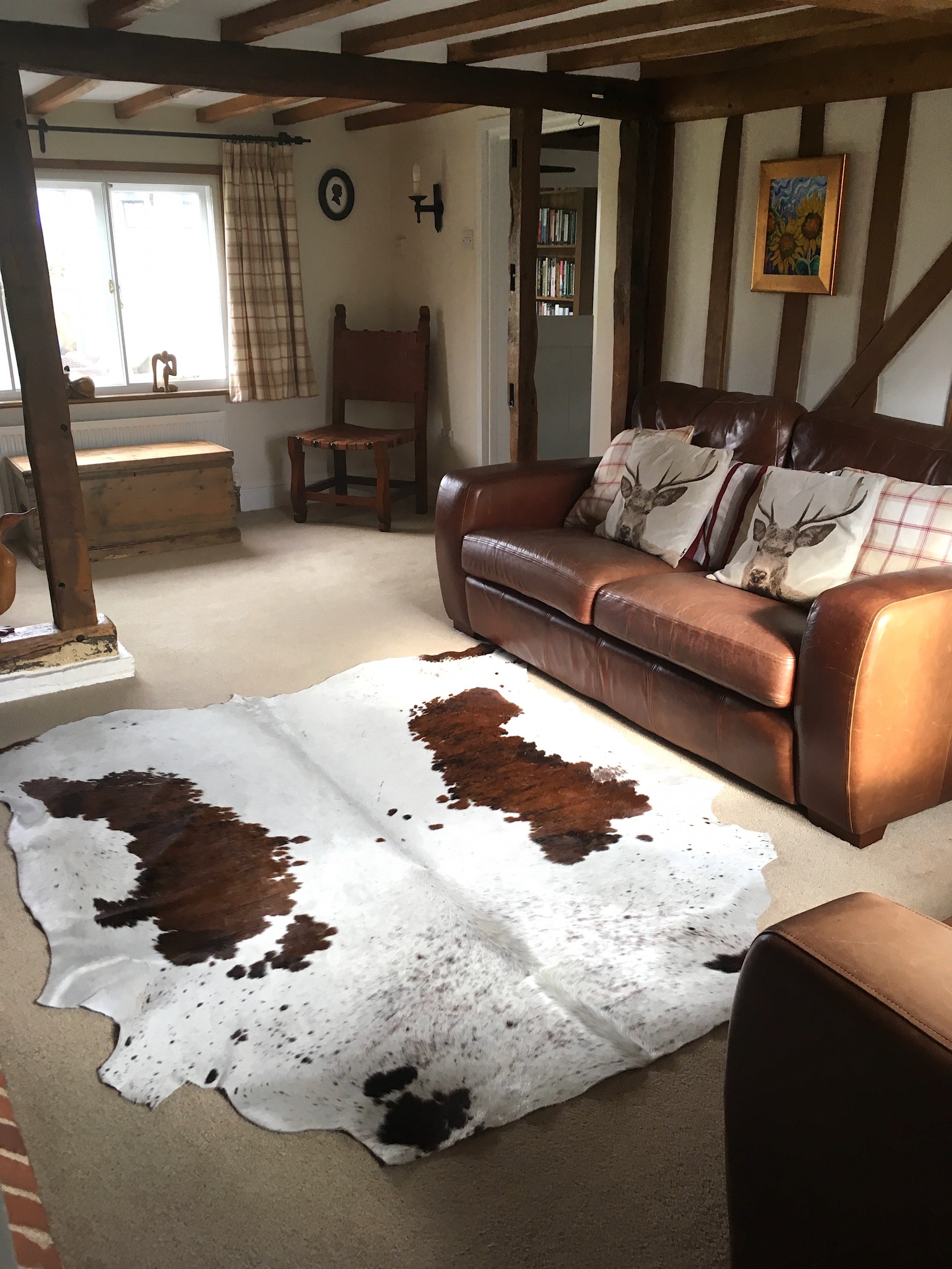 Nguni cowhide rugs, brown and white rugs, cowhides, skins, animal print, cowhide, luxury interiors, home interiors, interior styling, soft furnishings, sustainable, living room decor, floor art