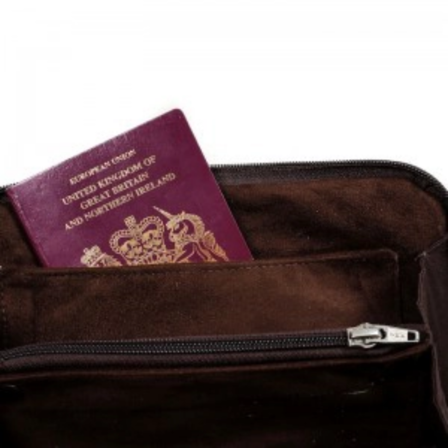 Close-up view of the cowhide travel wallet/clutch, showcasing the luxurious suede interior with multiple compartments for organisation