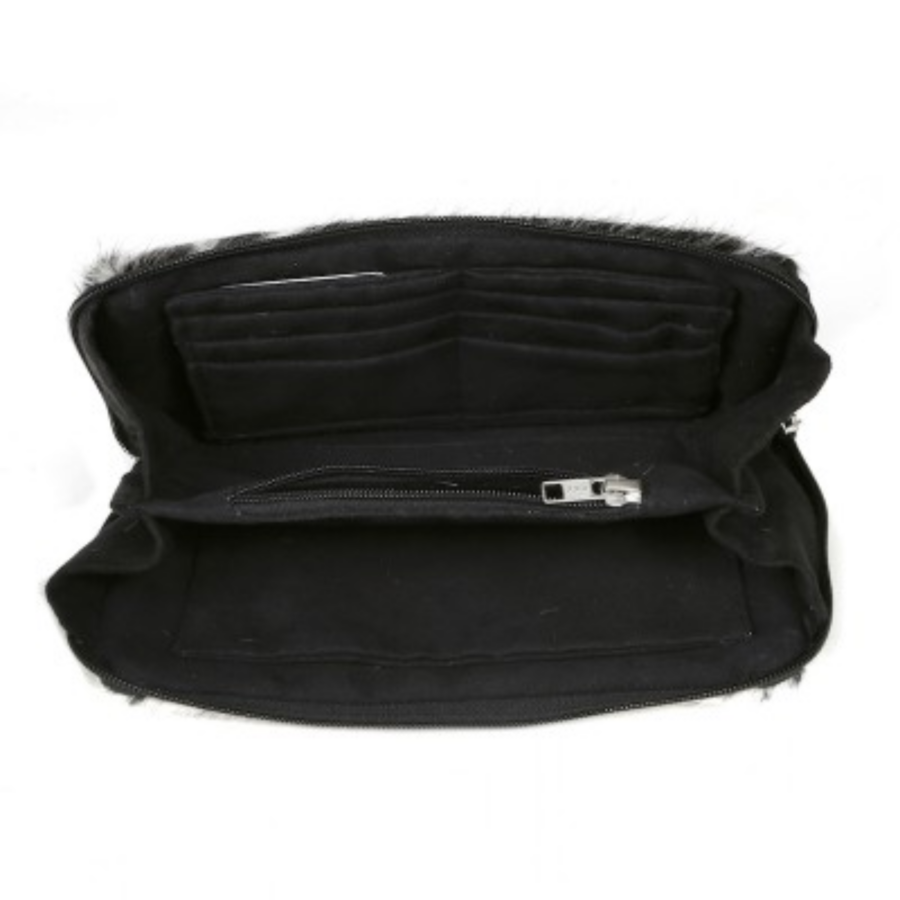 Close-up view of the cowhide travel wallet/clutch, showcasing the luxurious suede interior with multiple compartments for organisation