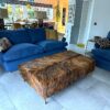 modern bespoke cowhide footstool in a sitting room