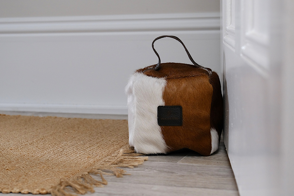 brown and white cowhide doorstop