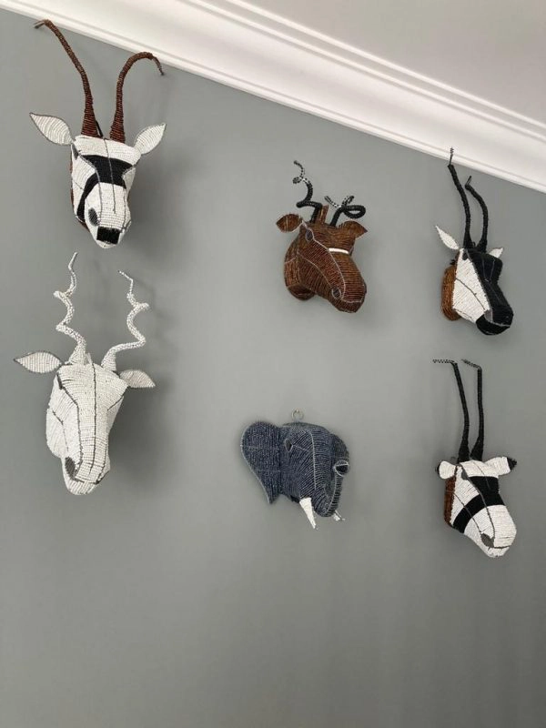 Collection of 6 beaded animal heads mounted onto a Grey wall for decoration