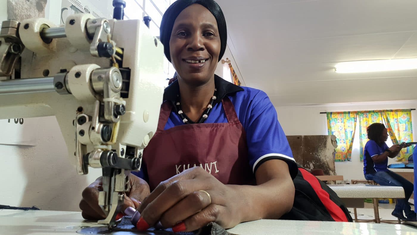 Women sewing cowhide leather for our ethically sourced products