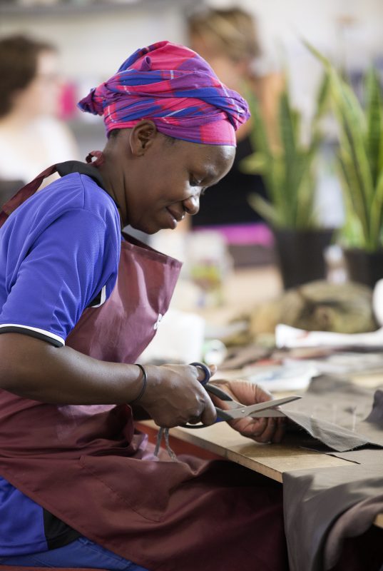 Zulu Women working, cutting leather for cowhide sustainable products