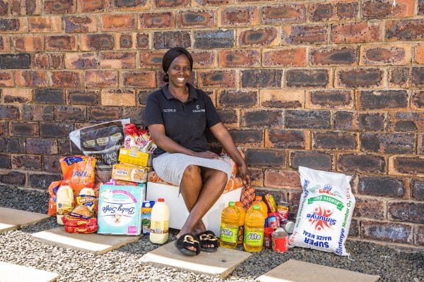 Gcinile (one of Zulucow's talented seamstresses) with some of the groceries she bought with your donations