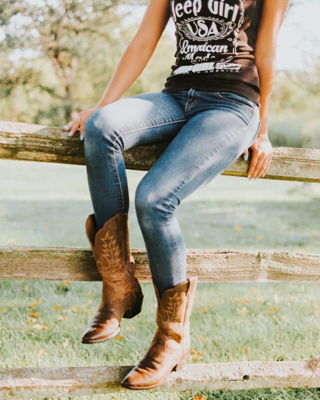 cowgirl women in denim jeans and cowboy leather boots, western cowgirl chic