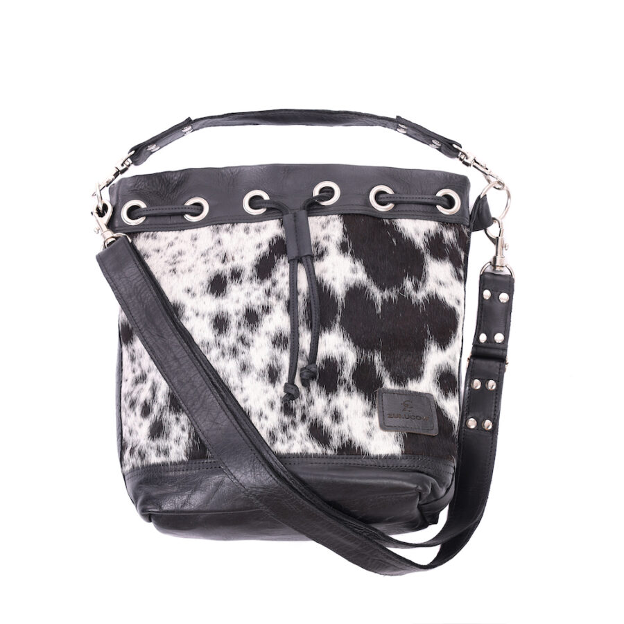Ethically-made, cow print, leather bucket bag featuring distinctive cowhide front and leather back