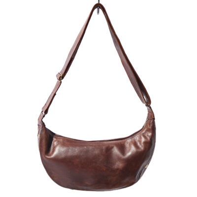 Ethically made cow print cowhide sling bag with adjustable leather strap and top zip closure