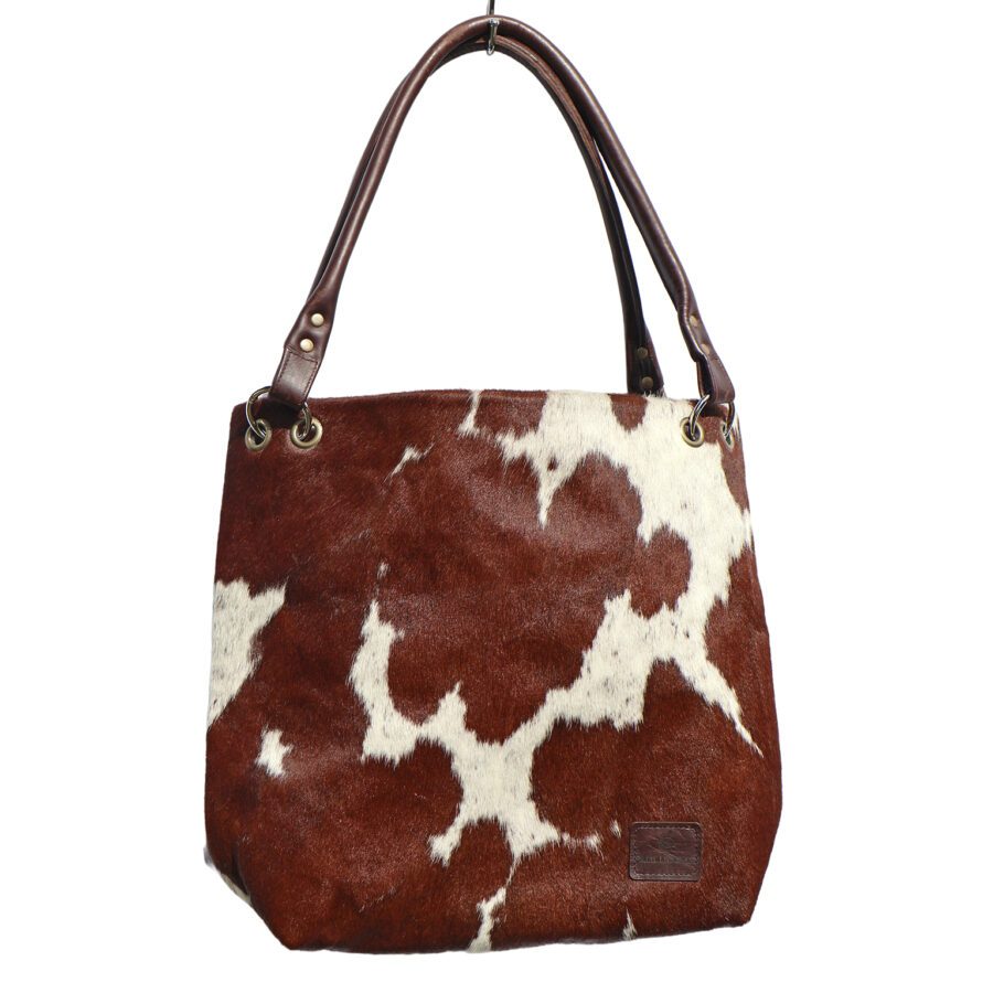 Handmade cow-print slouch bag – ethically crafted, sustainable cowhide leather handbag for a unique, luxury statement piece.