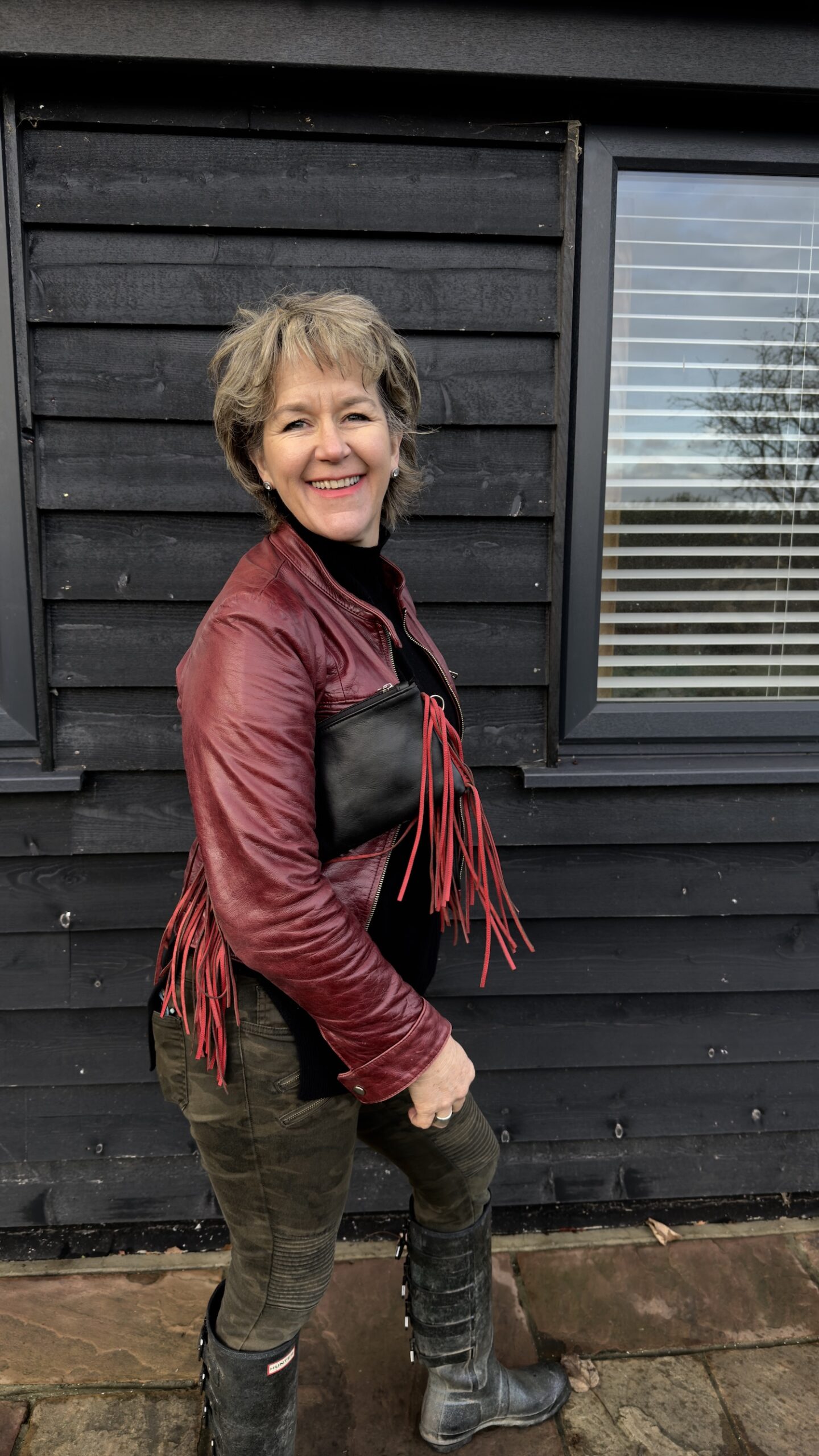 back of black leather cowhide purse with red fringes