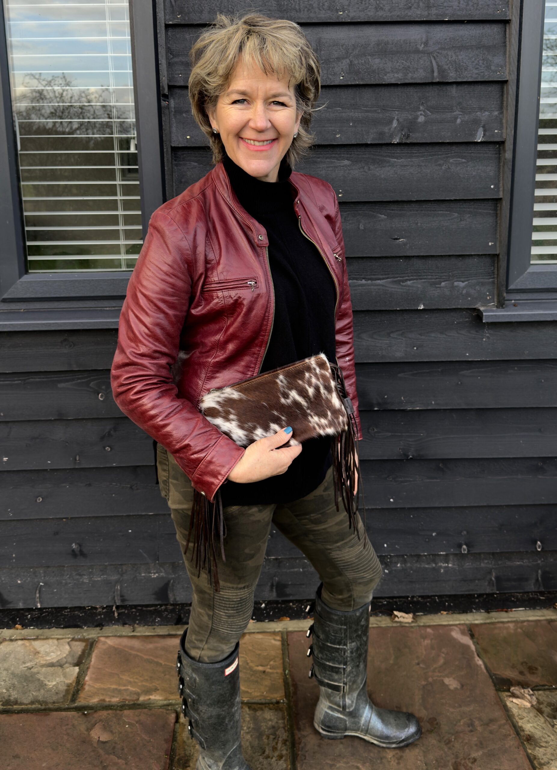 brown and white cowhide western purse with brown fringes